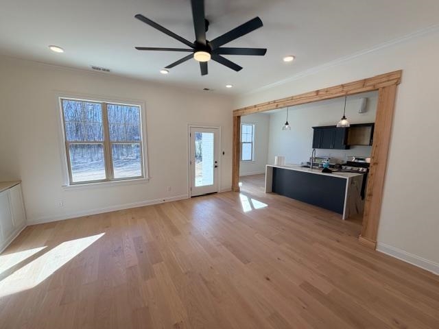 2939 Brighton-Clopton Road Brighton, TN 38011 - Photo 23 of 23 Kitchen with dark cabinetry, open floor plan, light countertops, light wood finished floors, and decorative light fixtures