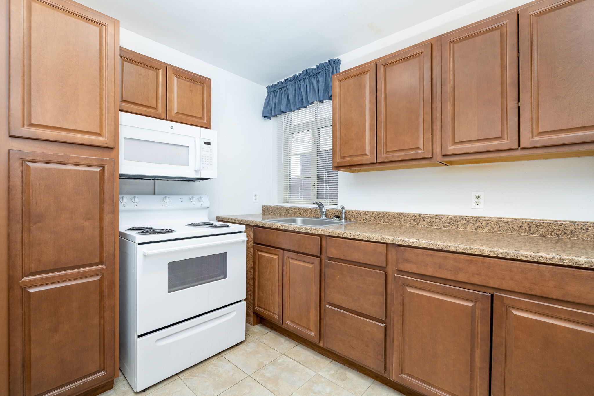 869 Farmington Avenue, Unit 305 West Hartford, CT 06119 - Photo 12 of 30 a kitchen with granite countertop cabinets stainless steel appliances and sink