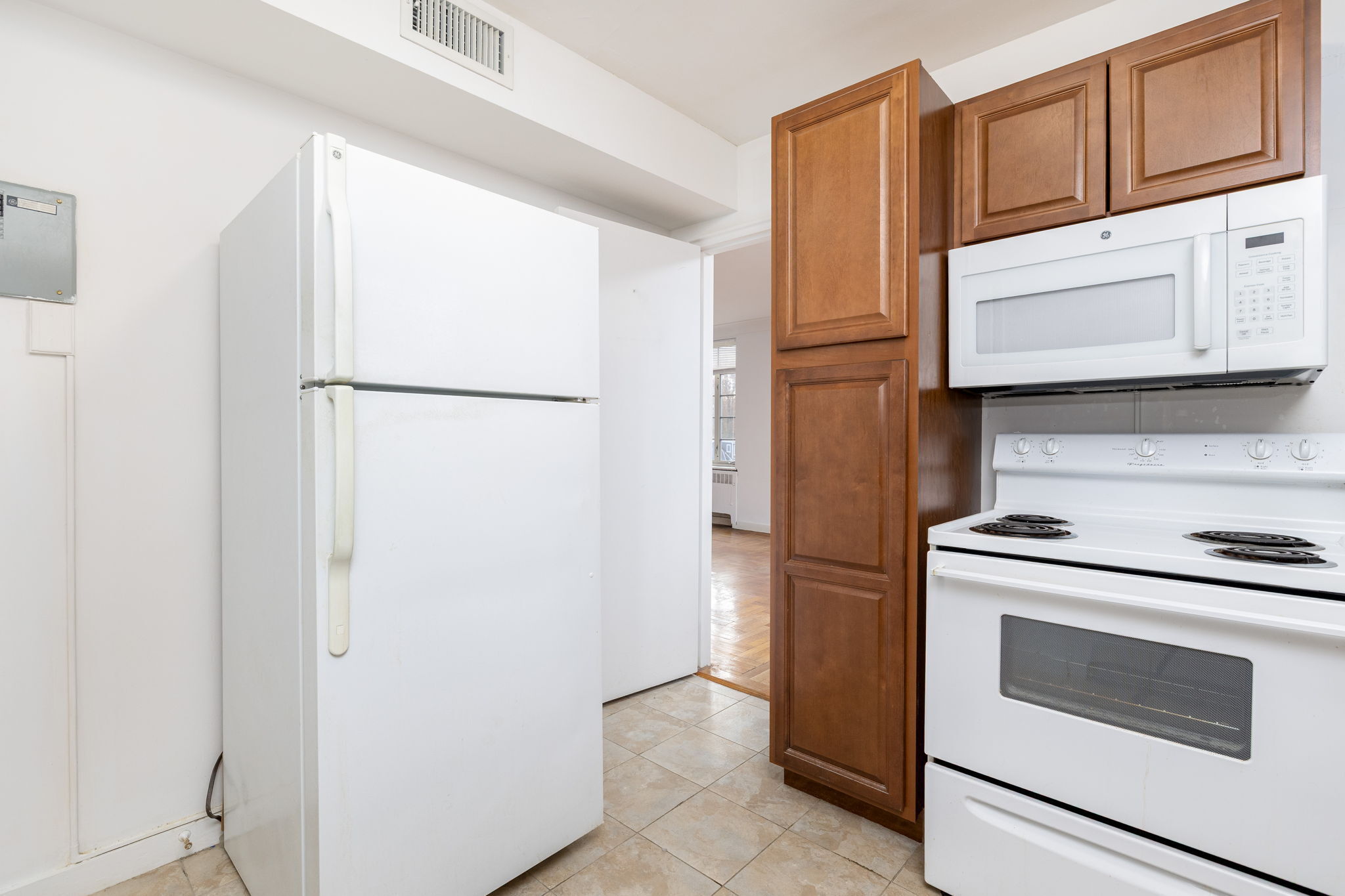 869 Farmington Avenue, Unit 305 West Hartford, CT 06119 - Photo 13 of 30 a kitchen with stainless steel appliances white cabinets and a refrigerator