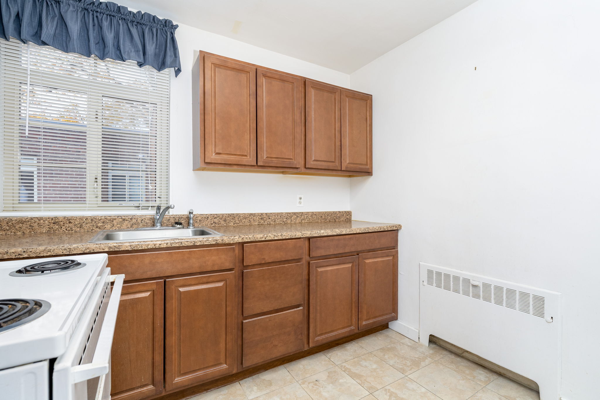 869 Farmington Avenue, Unit 305 West Hartford, CT 06119 - Photo 14 of 30 a kitchen with a sink cabinets and window
