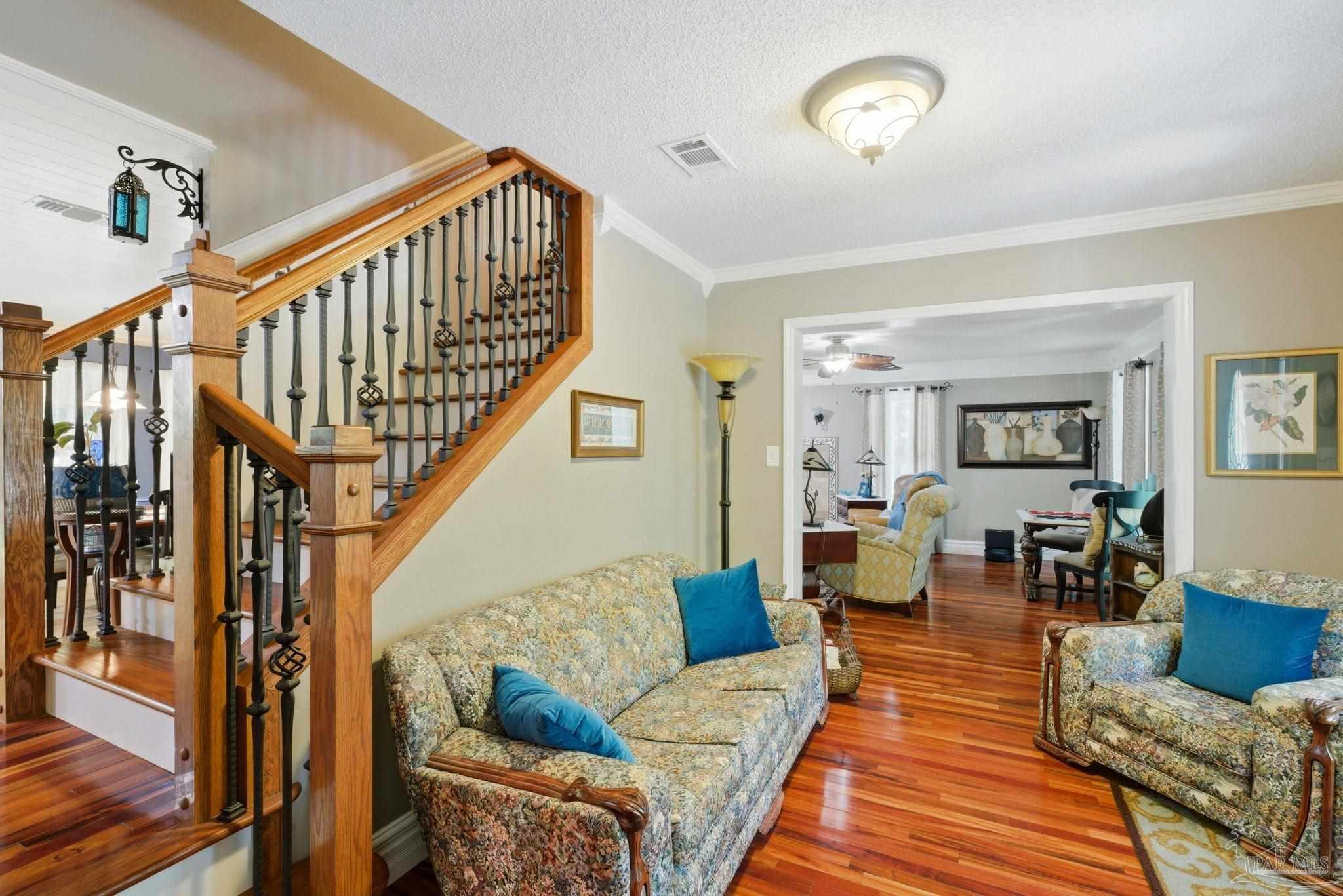 6930 Summit Way Milton, FL 32570 - Photo 6 of 71 a living room with fireplace furniture and a wooden floor