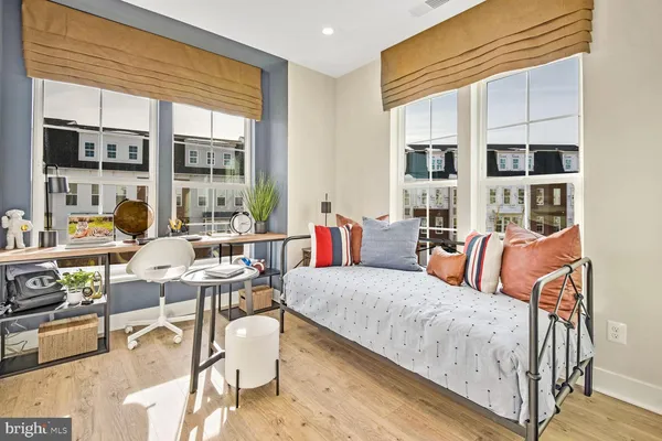 a living room with furniture a flat screen tv and a large window