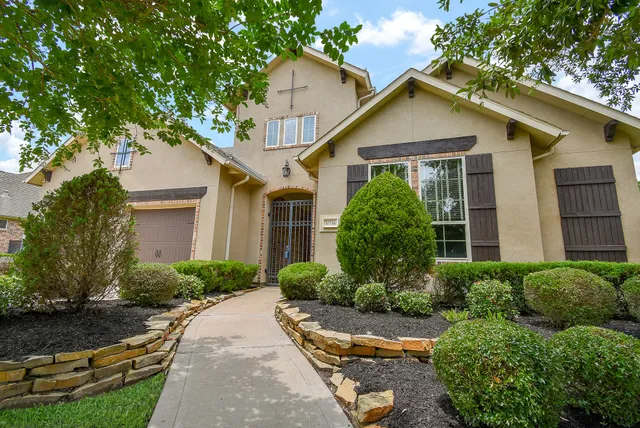 a kitchen with stainless steel appliances kitchen island granite countertop a table chairs sink and cabinets