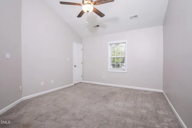 a kitchen with stainless steel appliances a stove a sink dishwasher a refrigerator white cabinets and wooden floor