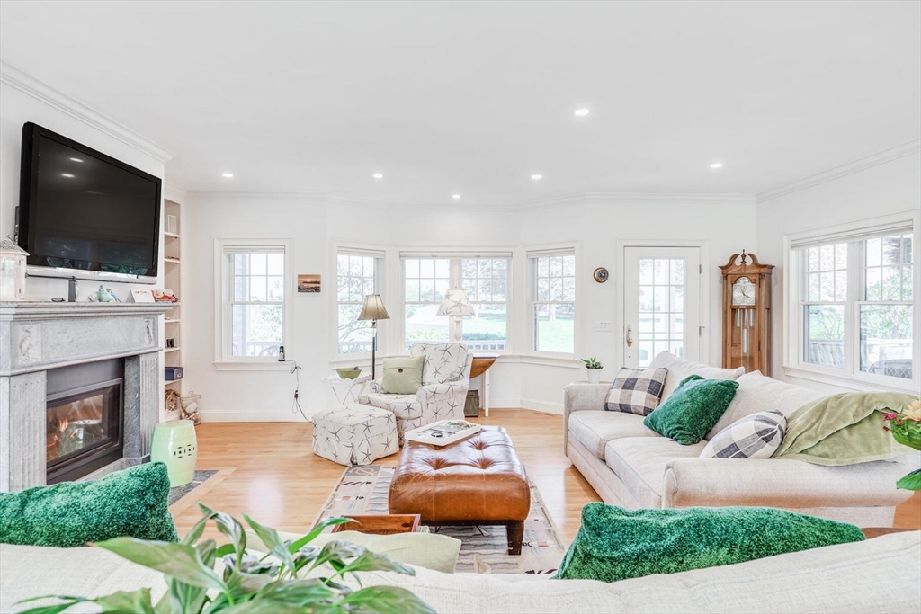 55 Cove Road Eastham, MA 02642 - Photo 13 of 42 a living room with fireplace furniture and a flat screen tv