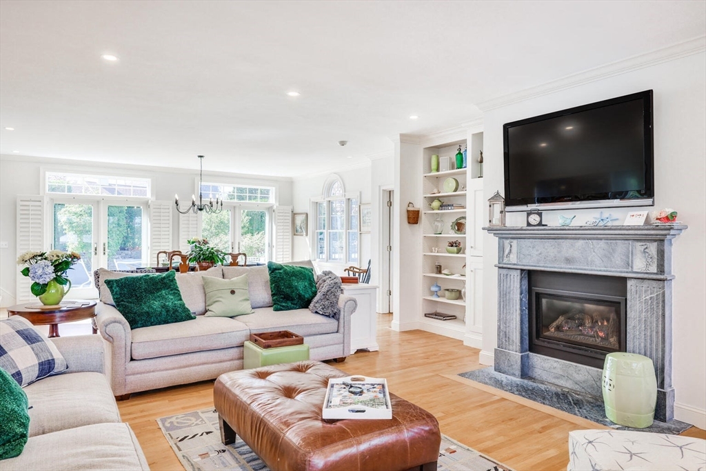 55 Cove Road Eastham, MA 02642 - Photo 15 of 42 a living room with furniture a flat screen tv and a fireplace