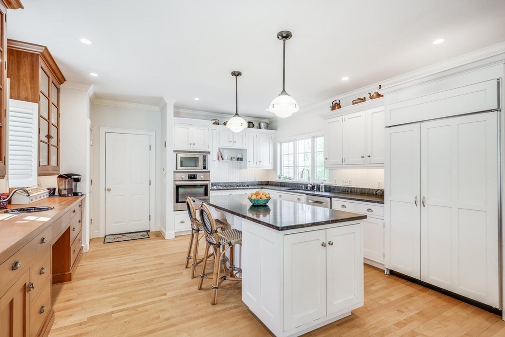 55 Cove Road Eastham, MA 02642 - Photo 19 of 42 a kitchen with stainless steel appliances granite countertop a sink a stove and a refrigerator