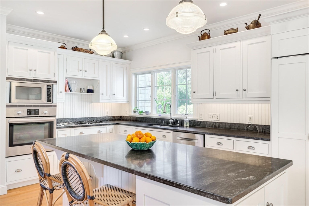 55 Cove Road Eastham, MA 02642 - Photo 20 of 42 a kitchen with stainless steel appliances granite countertop a sink a stove counter space and cabinets