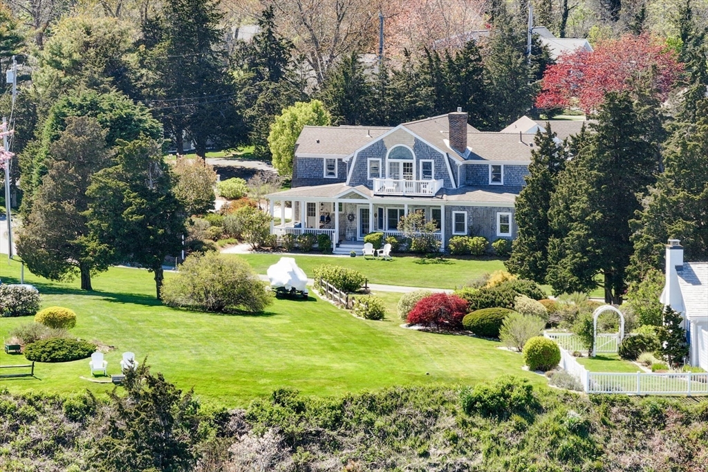 55 Cove Road Eastham, MA 02642 - Photo 2 of 42 a front view of a house with garden