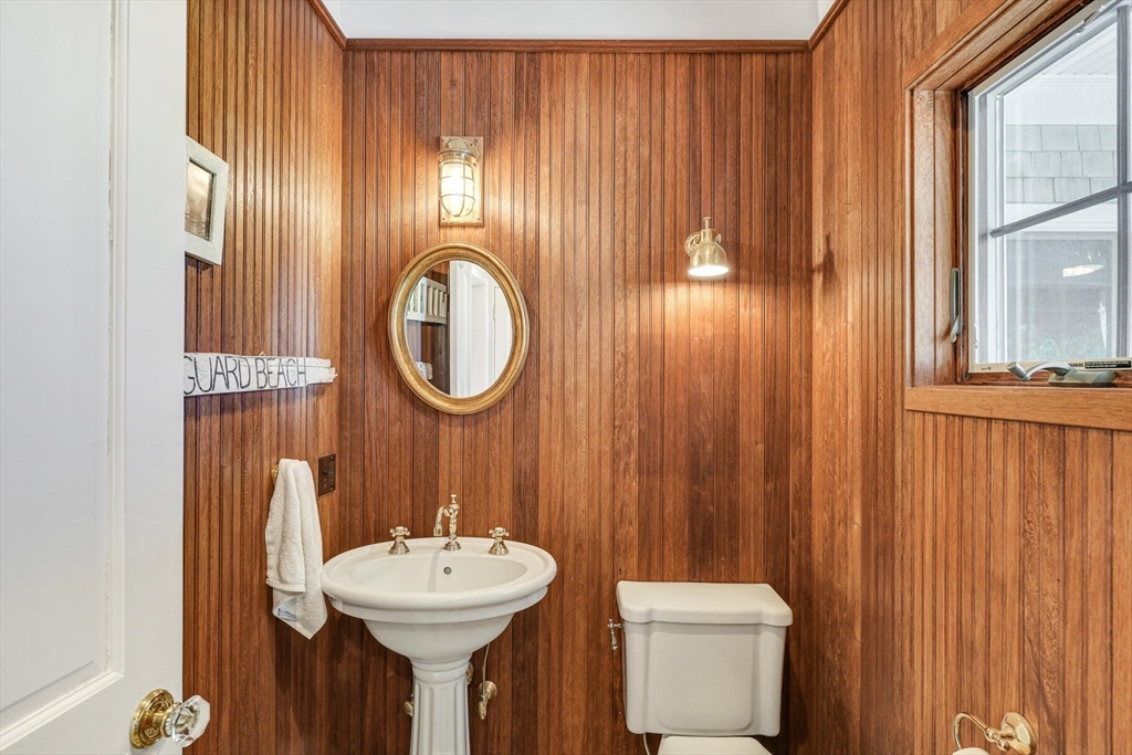 55 Cove Road Eastham, MA 02642 - Photo 22 of 42 a bathroom with a sink a mirror and a toilet