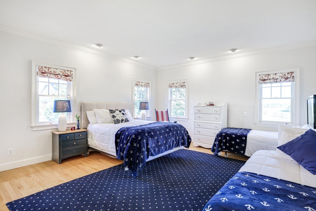 55 Cove Road Eastham, MA 02642 - Photo 23 of 42 a spacious bedroom with double bed and a window