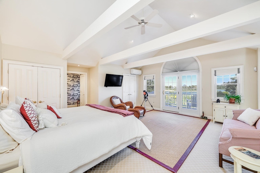 55 Cove Road Eastham, MA 02642 - Photo 30 of 42 a bedroom with a large bed and a large window