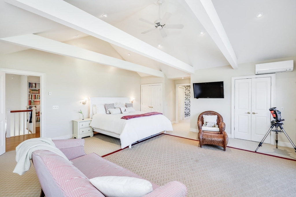 55 Cove Road Eastham, MA 02642 - Photo 31 of 42 a spacious bedroom with a bed and a flat screen tv