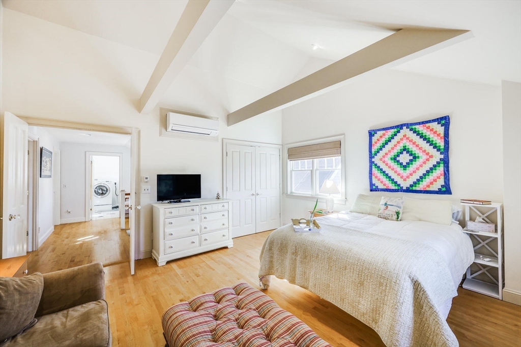 55 Cove Road Eastham, MA 02642 - Photo 36 of 42 a bedroom with a bed and a flat screen tv