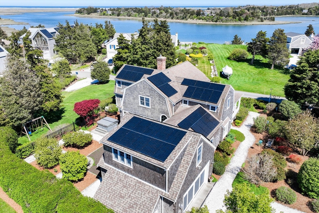 55 Cove Road Eastham, MA 02642 - Photo 5 of 42 an aerial view of a house with a garden and lake view