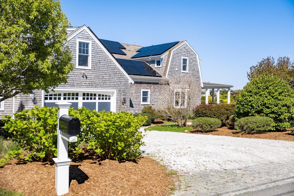 55 Cove Road Eastham, MA 02642 - Photo 7 of 42 a front view of a house with a yard