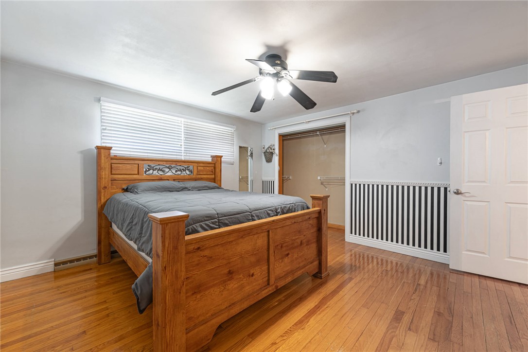 5235 West Ridgewood Road Springfield, OH 45503 - Photo 15 of 32 This spacious bedroom features hardwood flooring and a functional ceiling fan for comfort.
