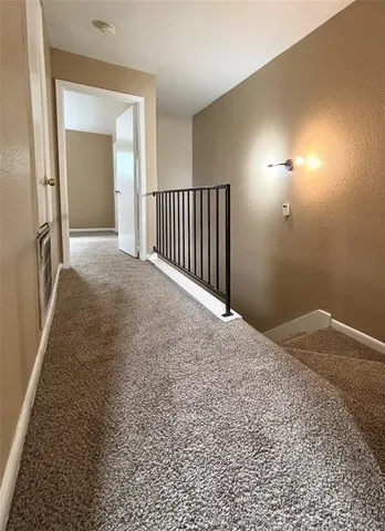 a view of a hallway view with staircase