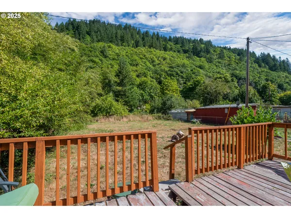 a view of balcony with wooden floor and fence