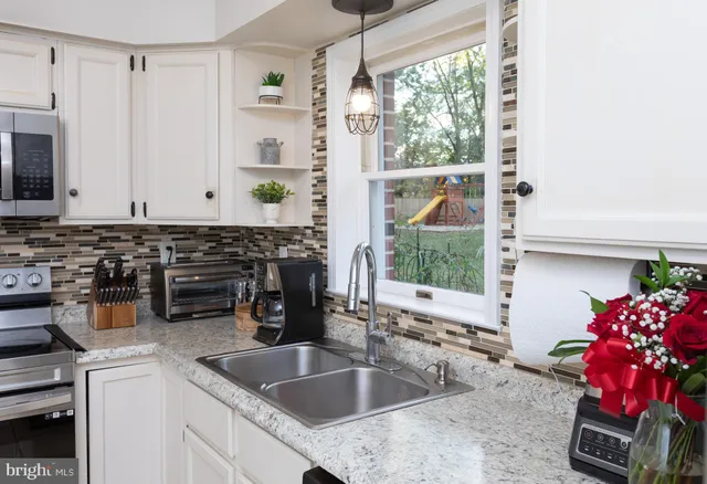 a kitchen with a sink and a stove