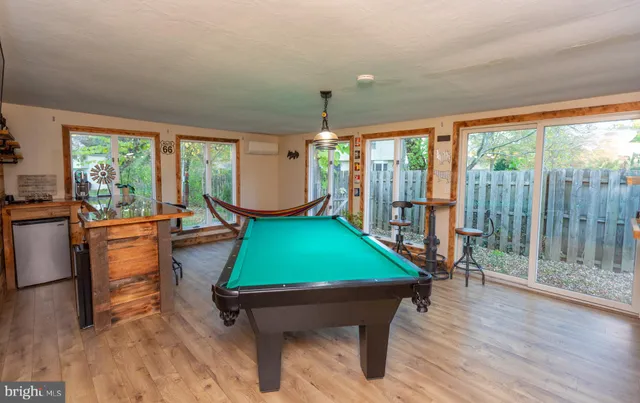 a room with pool tables and windows