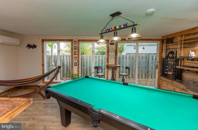 a room with pool tables and windows
