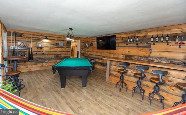 a room with lots of wooden furniture and a table