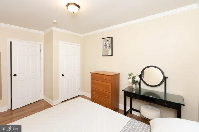 a bedroom with a bed and a dresser