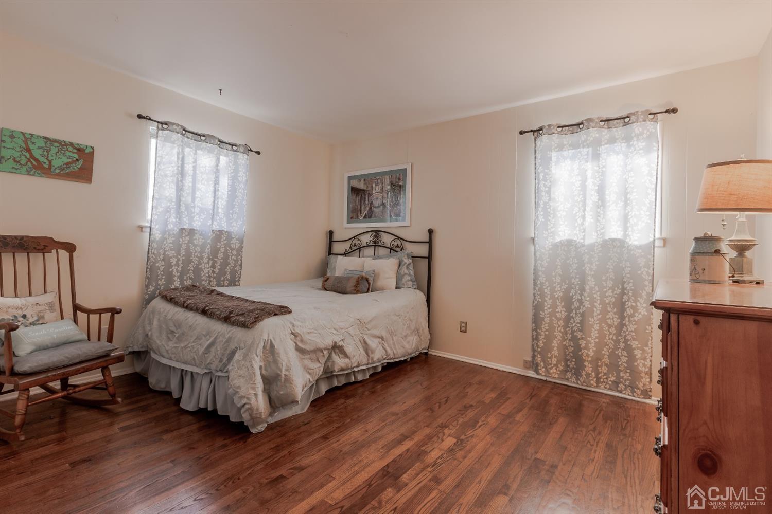 28 Atlantic Road Somerset, NJ 08873 - Photo 11 of 18 a bedroom with a bed and wooden floor