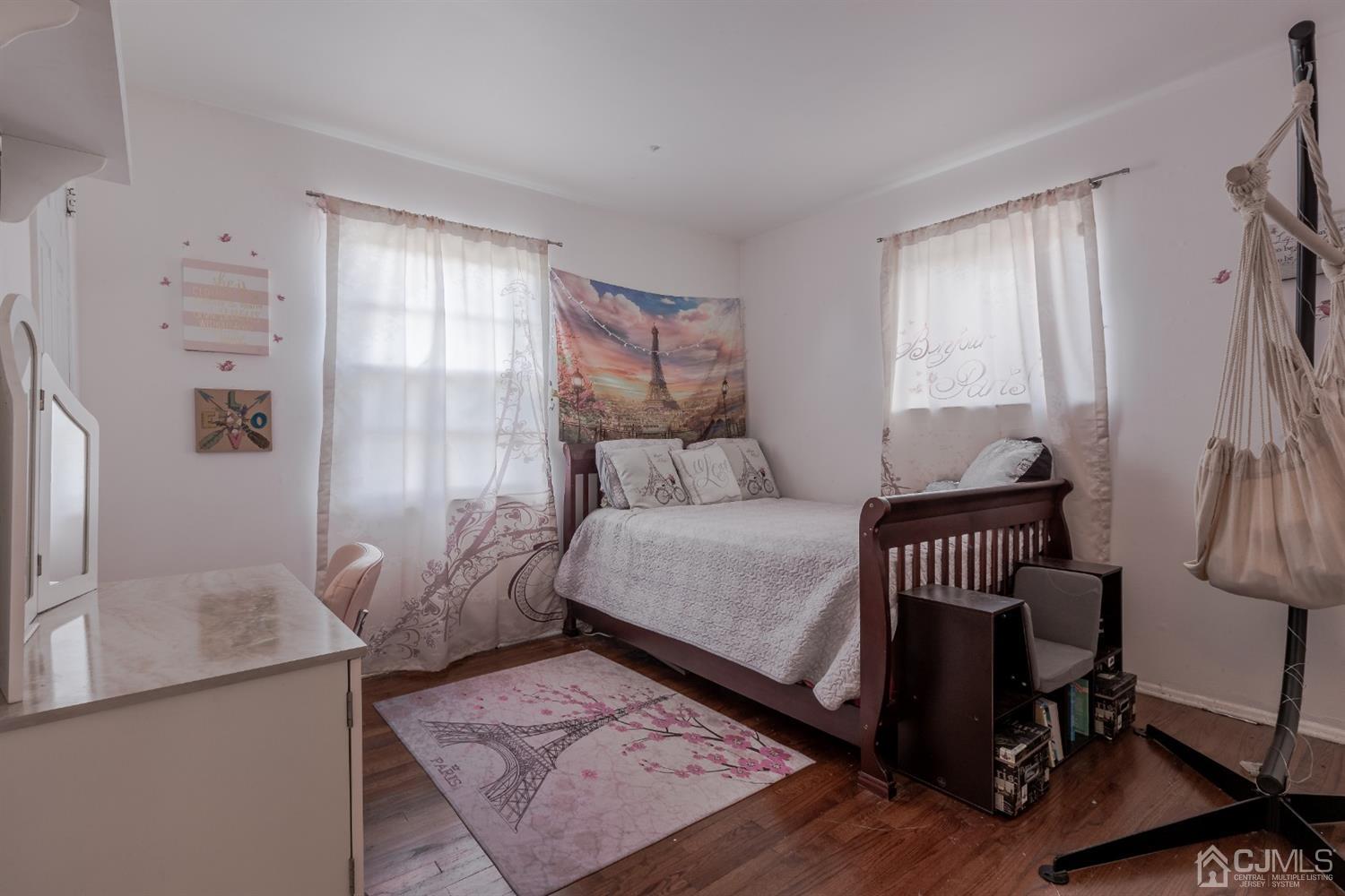 28 Atlantic Road Somerset, NJ 08873 - Photo 13 of 18 a bedroom with a bed and wooden floor