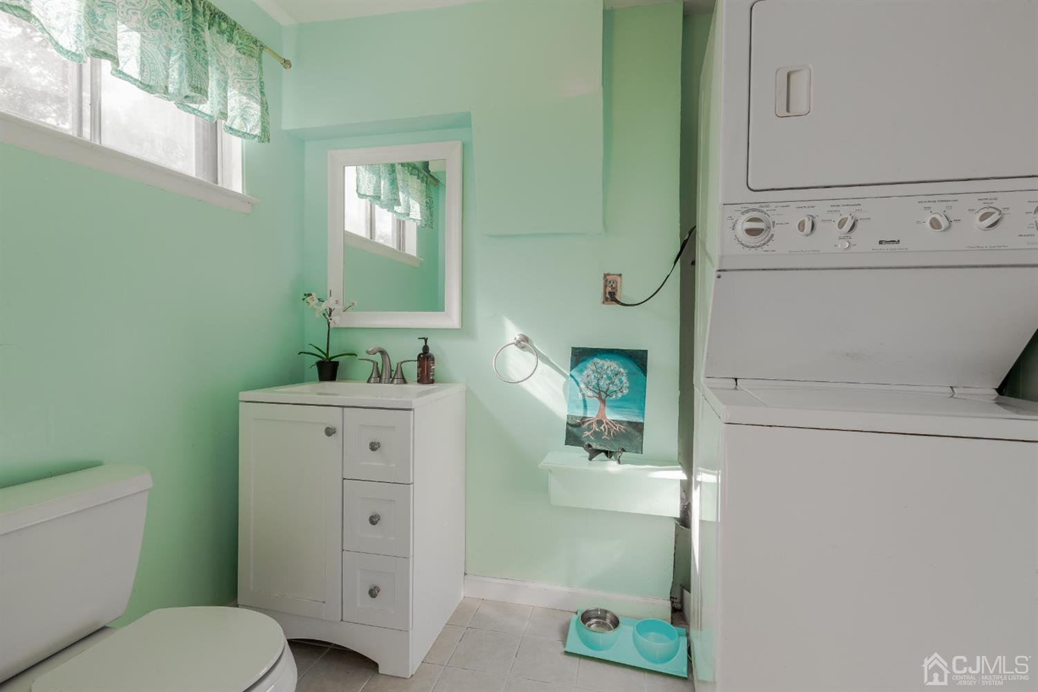 28 Atlantic Road Somerset, NJ 08873 - Photo 15 of 18 a bathroom with a granite countertop toilet a sink and a mirror