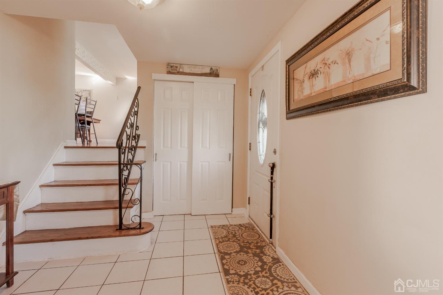 28 Atlantic Road Somerset, NJ 08873 - Photo 3 of 18 a view of a hallway with wooden floor and entryway