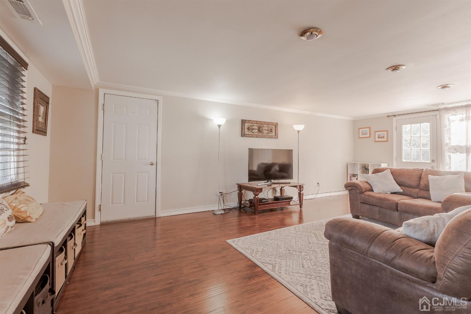 28 Atlantic Road Somerset, NJ 08873 - Photo 4 of 18 a living room with furniture and a flat screen tv