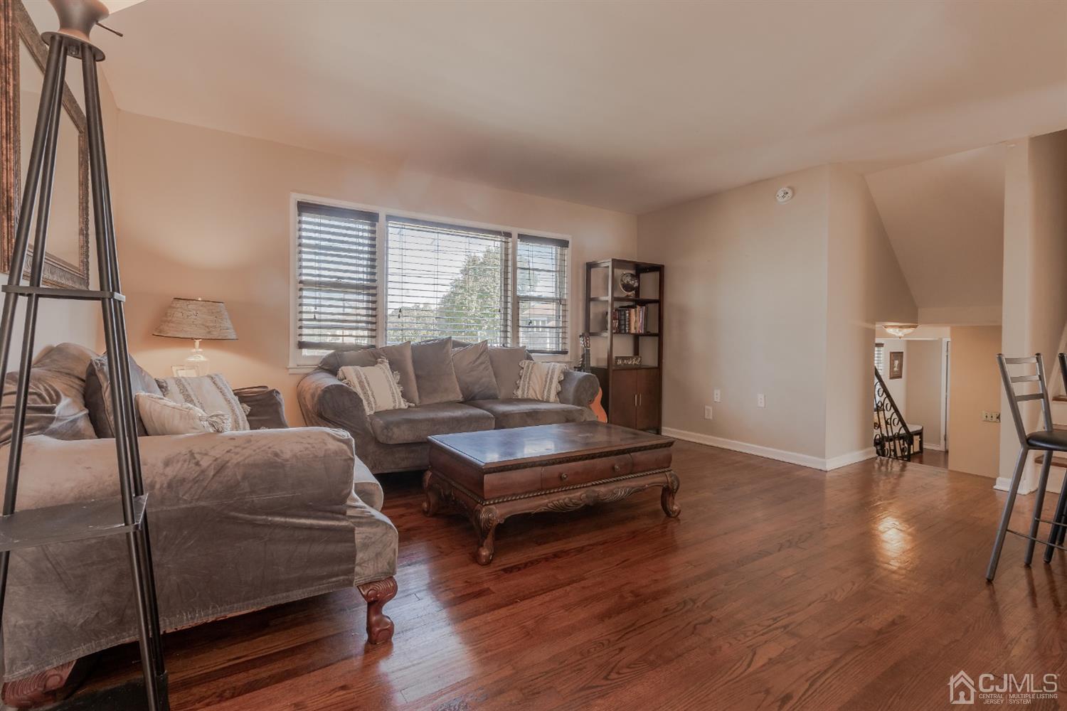 28 Atlantic Road Somerset, NJ 08873 - Photo 6 of 18 a living room with furniture and a wooden floor