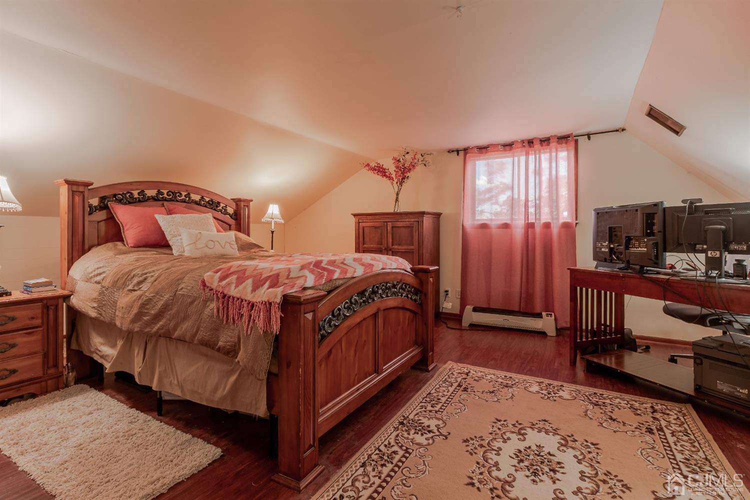 28 Atlantic Road Somerset, NJ 08873 - Photo 10 of 18 a bedroom with a bed and a dresser with wooden floor