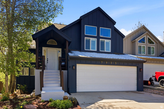 7935 Mustang Loop Road Park City, UT 84098 - Photo 1 of 60 Contemporary dark-paneled exterior with a white front entry door and a covered porch featuring wood-finish columns and railings
