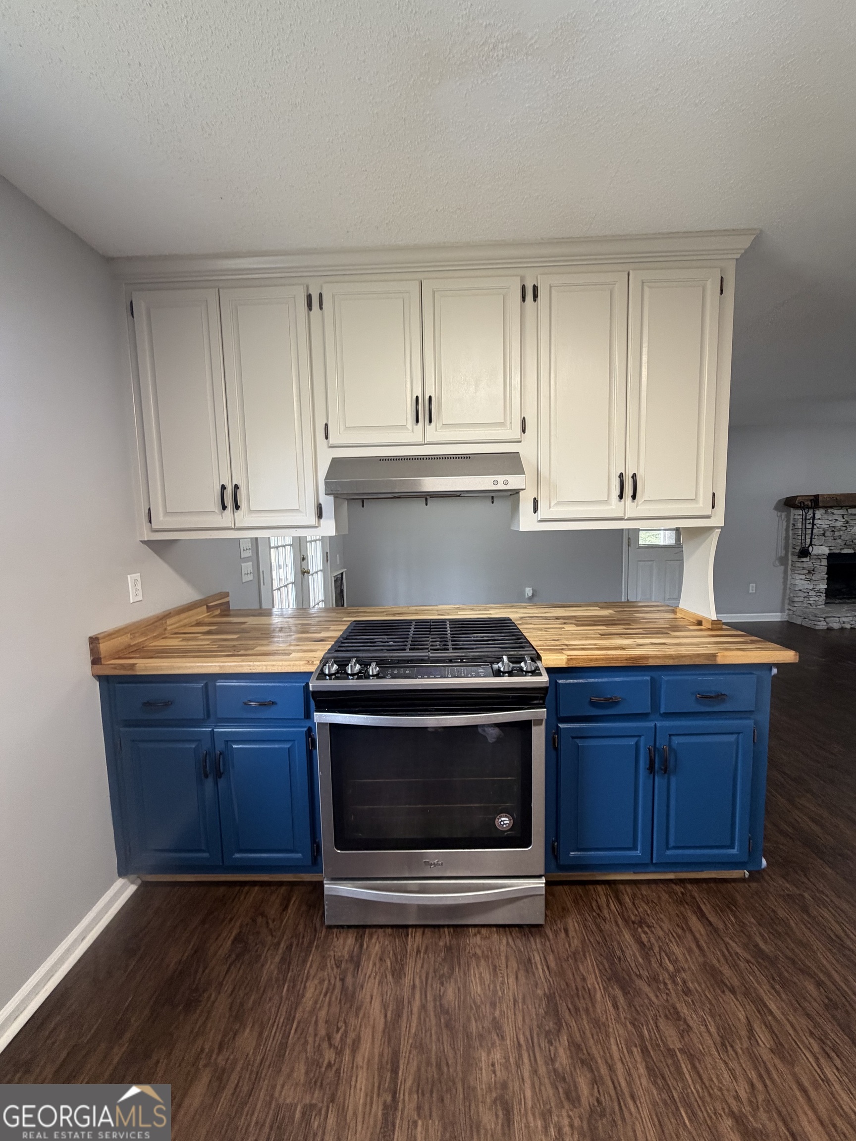 1410 Greensboro Road Madison, GA 30650 - Photo 12 of 17 a kitchen with wooden floors and stainless steel appliances