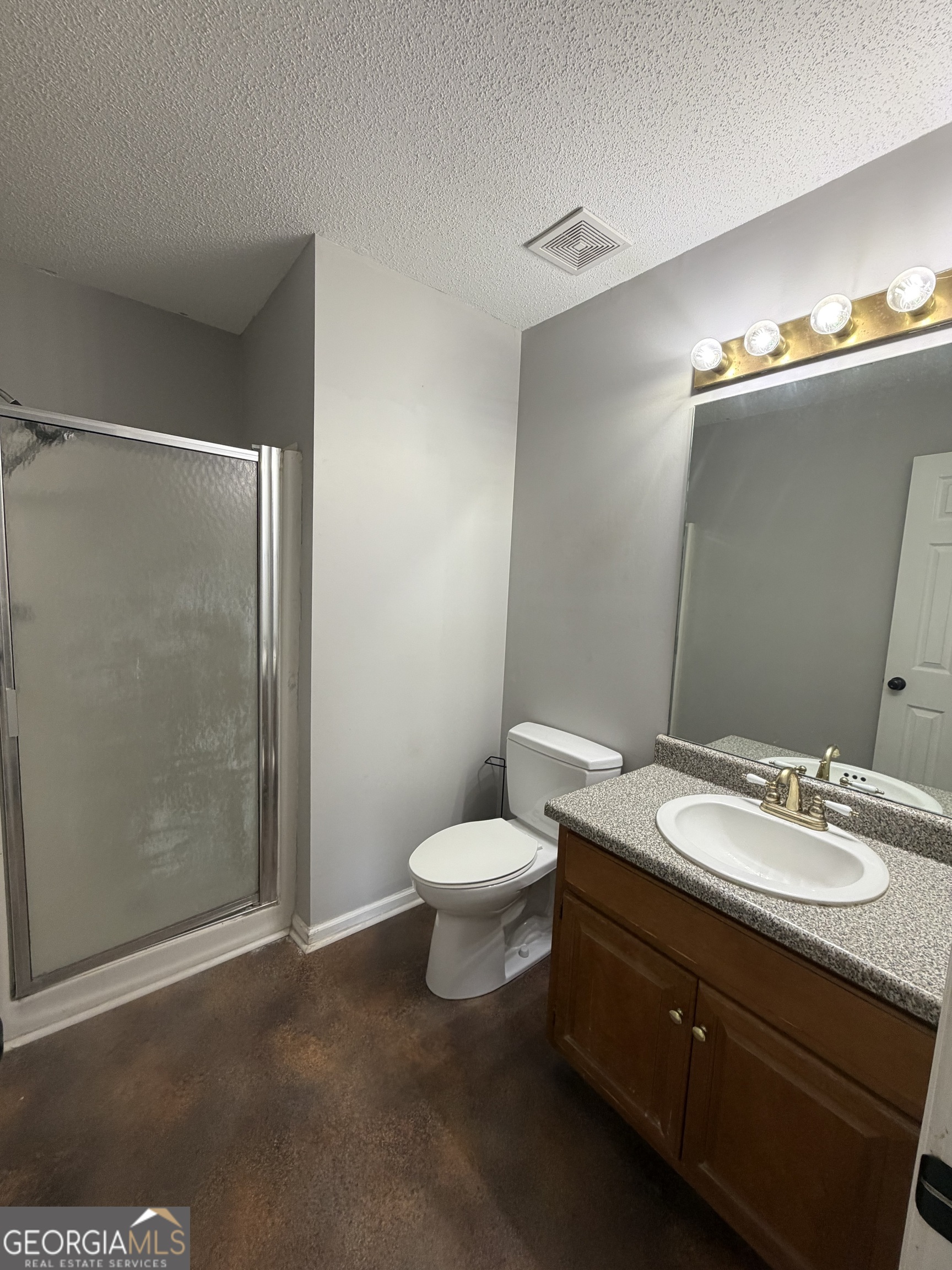 1410 Greensboro Road Madison, GA 30650 - Photo 15 of 17 a bathroom with a granite countertop sink toilet and shower