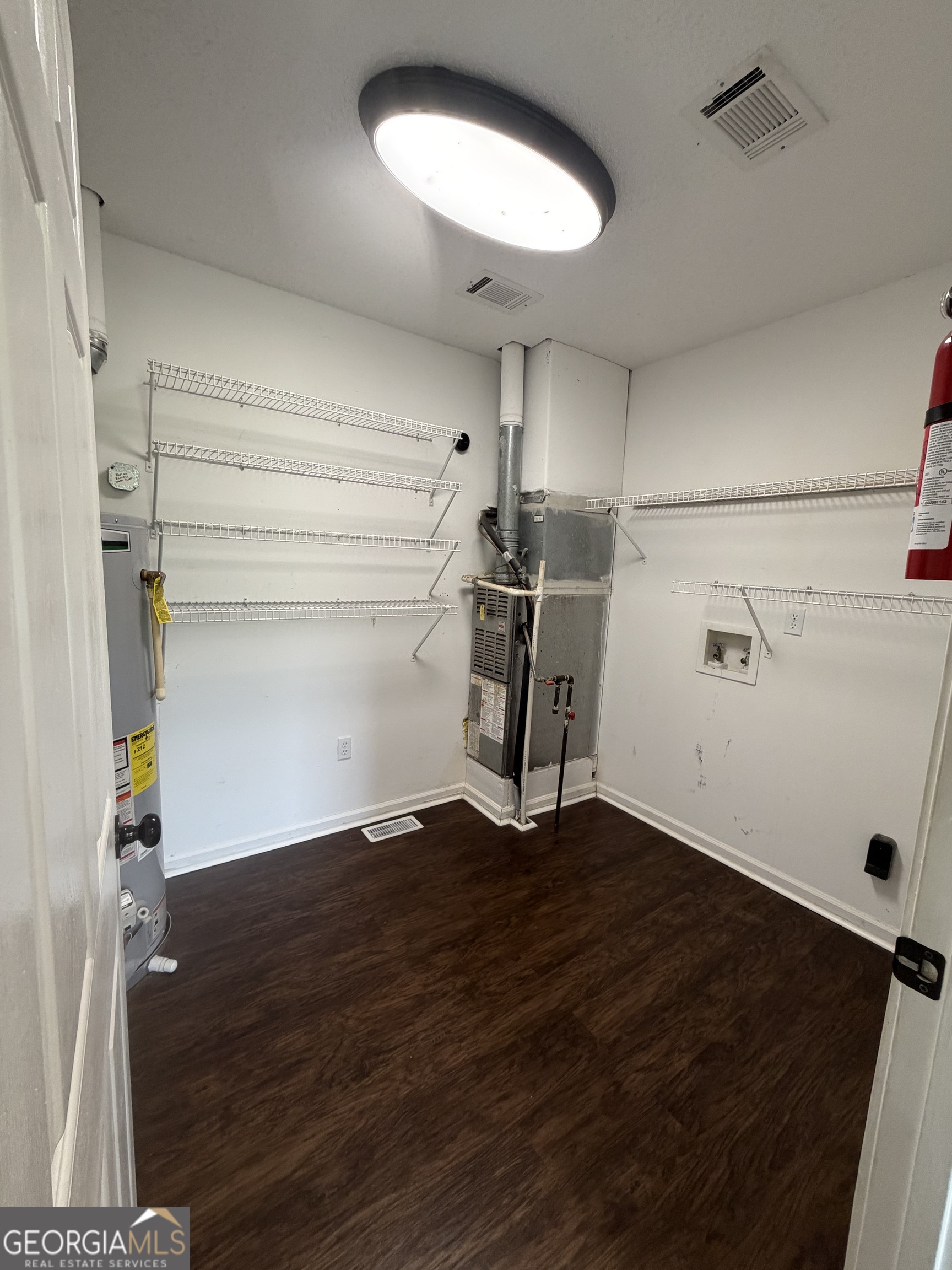 1410 Greensboro Road Madison, GA 30650 - Photo 17 of 17 a view of storage and utility room with wooden floor