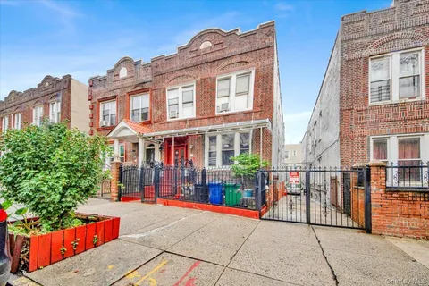 a front view of a building with a garden