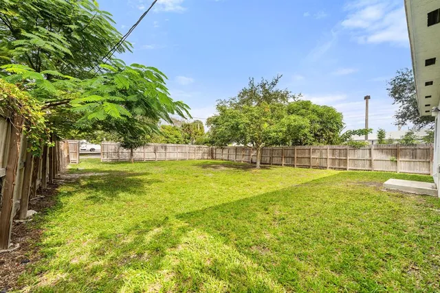 a view of yard with swimming pool and green space
