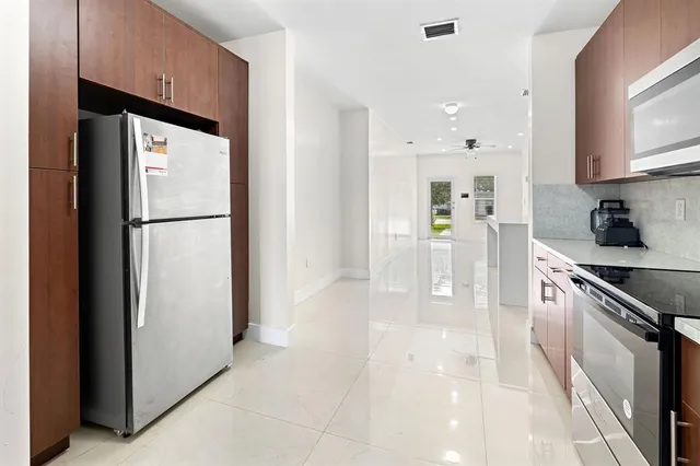 a kitchen with stainless steel appliances a refrigerator sink and cabinets