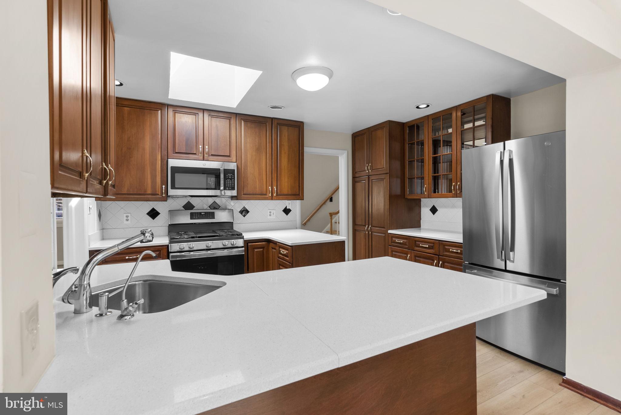 5108 Viking Road Bethesda, MD 20814 - Photo 17 of 51 a kitchen with stainless steel appliances a refrigerator sink and microwave