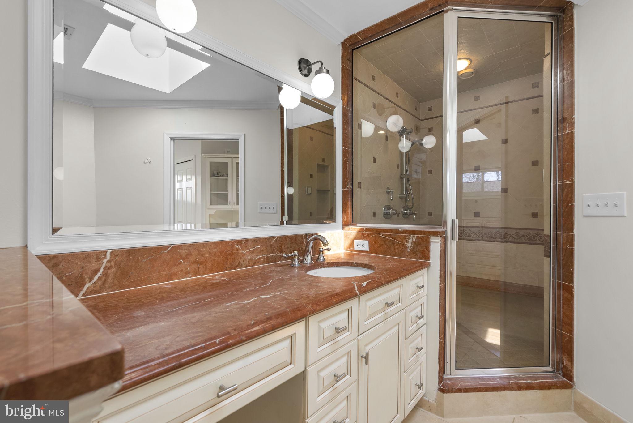 5108 Viking Road Bethesda, MD 20814 - Photo 26 of 51 a bathroom with a granite countertop sink a large mirror and a shower