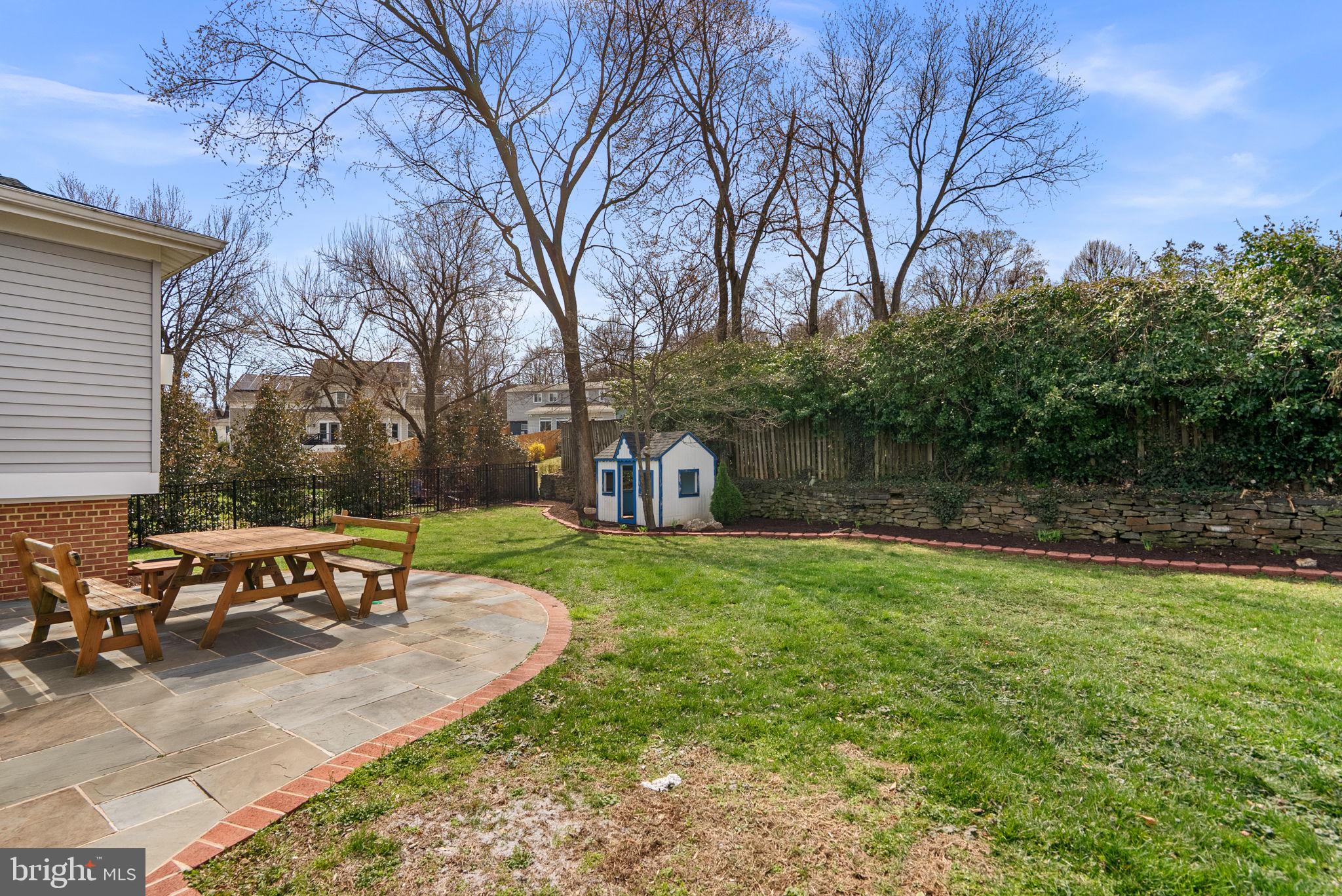5108 Viking Road Bethesda, MD 20814 - Photo 46 of 51 a view of a backyard with table and chairs and a fire pit