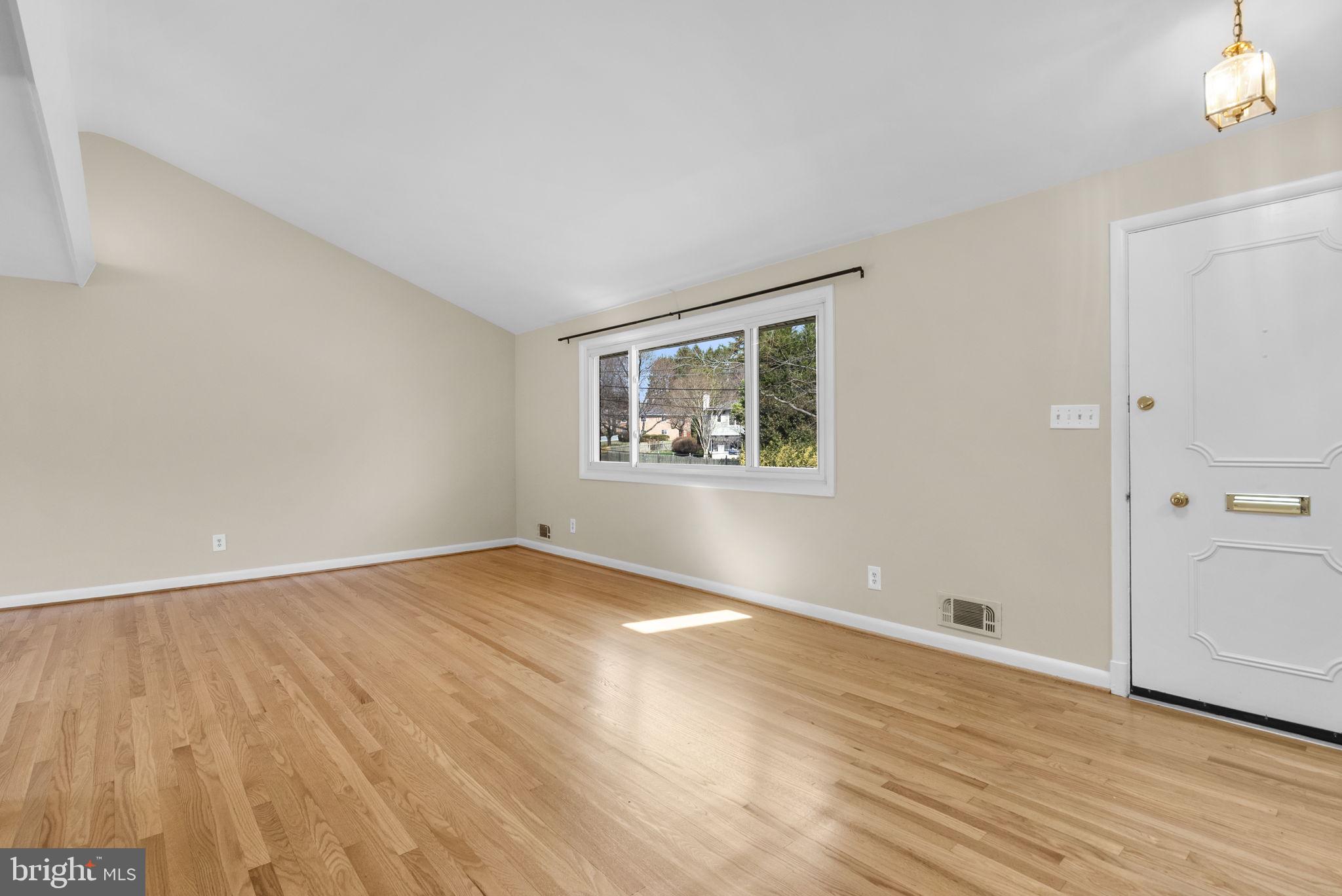 5108 Viking Road Bethesda, MD 20814 - Photo 6 of 51 an empty room with wooden floor and windows