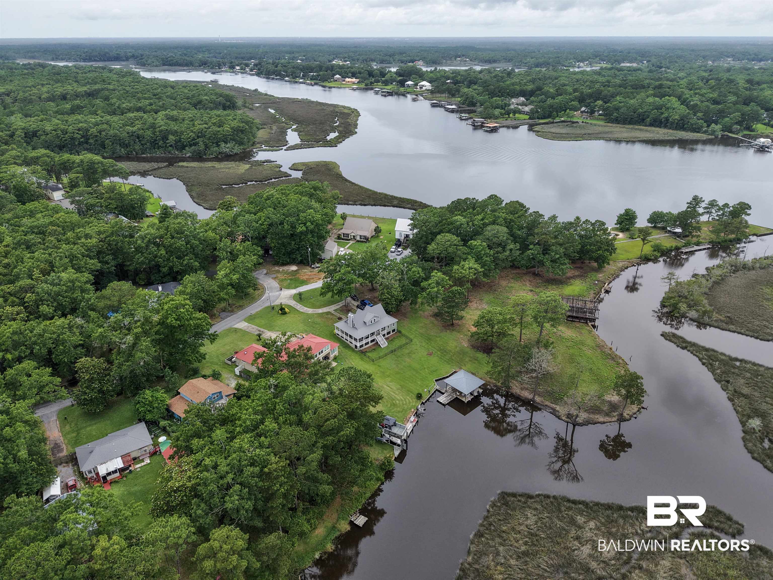 12171 Marguerite Drive Coden, AL 36523 - Photo 30 of 44 Expansive waterfront property featuring a private boat dock and covered boat lift