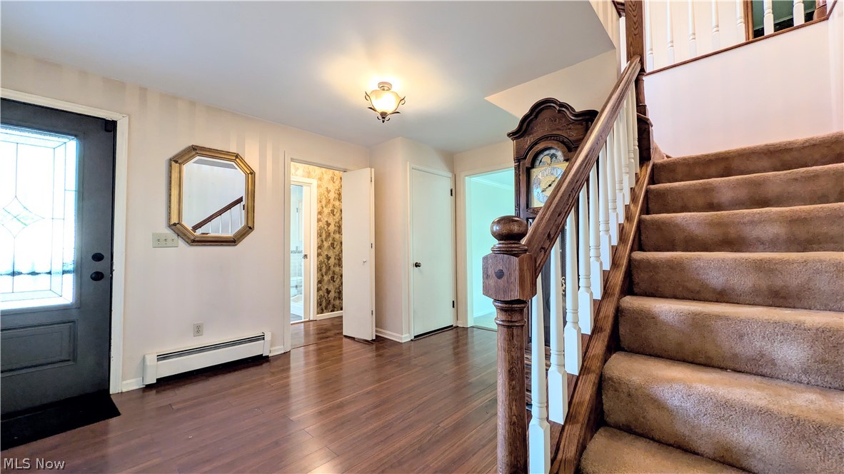 6409 Old Woods Road Ashtabula, OH 44004 - Photo 5 of 43 Entryway featuring wood-finish flooring and a carpeted staircase with wood banister and white spindles