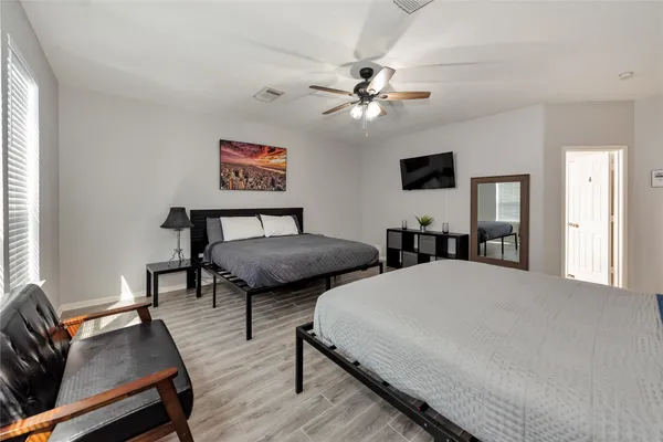 a bedroom with two beds and a couch