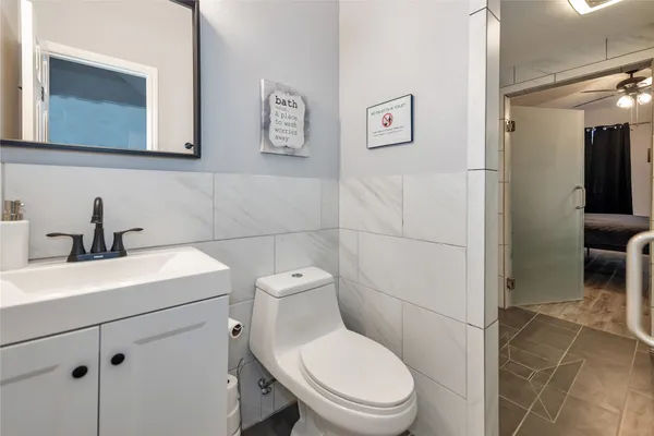 a bathroom with a toilet sink and mirror
